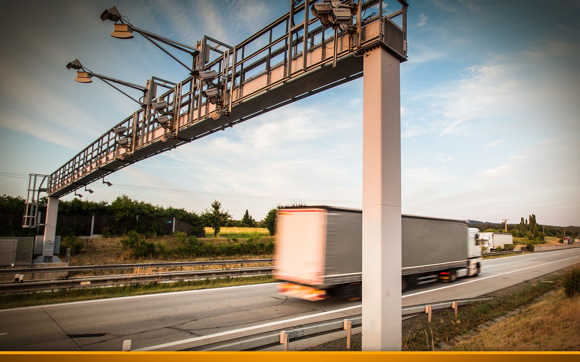 truck passing through a toll gate on a highway 