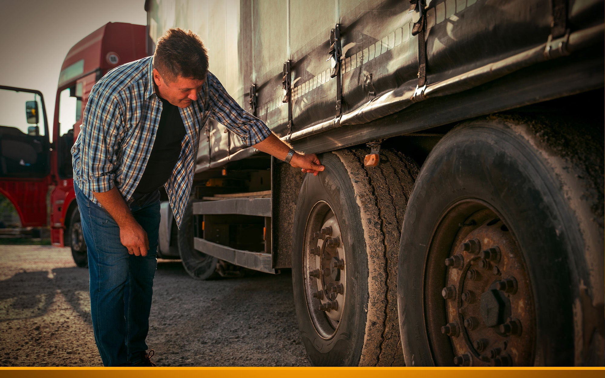 Truck driver checking tires before road